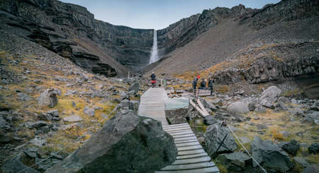 Hiking path to Hengifoss waterfall with blurred touristsの写真素材
