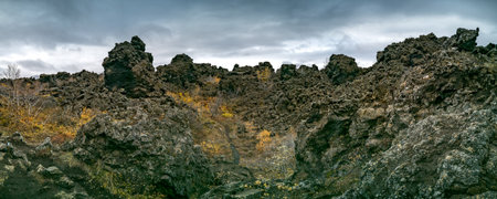 Massive Lava fields under dark cloudy day, panoramaの写真素材