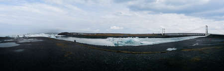 Jokulsarlon lagoon icebergs canal to the ocean with bridteの写真素材