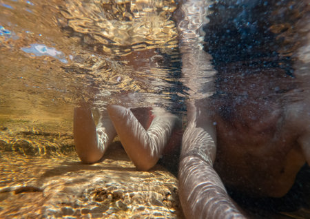 Relaxing under the water, couple in loveの写真素材