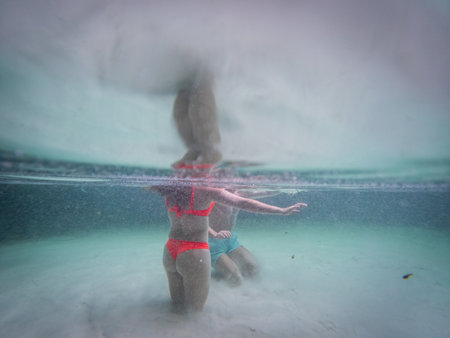 Two unidentified bodies buried in the sand underwater at Fervedouro in Jalapaoの写真素材