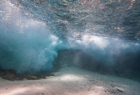 Crystal clear water under a white sandy waterfall with a mysterious atmosphereの写真素材