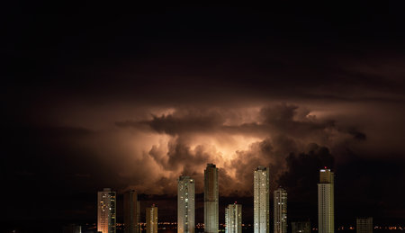 Orange storm clouds over city skyline at duskの写真素材