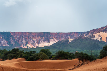 Majestic Mountains with Isolated Sand Dunes and Lush Greeneryの写真素材