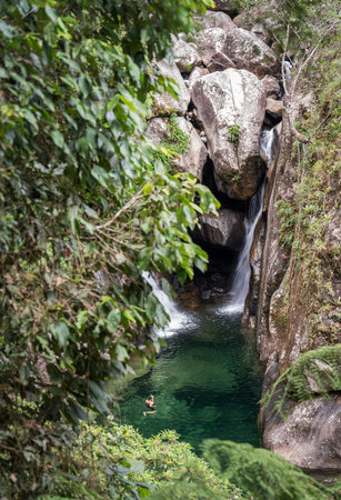 Refreshing Green Waterfall Bath in Remote Tropical Rainforestの写真素材