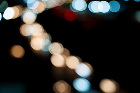 Blurred Motion of Glowing Multicolored Circles on Night Highway with Space for Textの写真素材