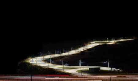 Long Exposure Night View of Highway with Light Trails and Illuminated Road Diversion .の写真素材