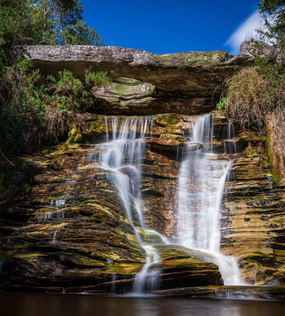 Picturesque Silky Waterfall Cascading Over Weathered Rock Formationの写真素材