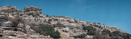 Trekkers Navigating Layered Rock Formations in Torcal de Antequeraの写真素材