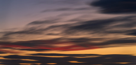 Peaceful Dusk: A Long Exposure of Clouds at Sunsetの写真素材