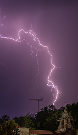 Intense Lightning Strike Over a Small Rural Churchの写真素材