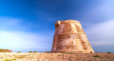 Long Exposure of Ancient Watchtower Under Silky Cloud Skyの写真素材