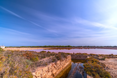 High Exposure Colorful Salt Pans Under Cloudy Sky with Copyspaceの写真素材