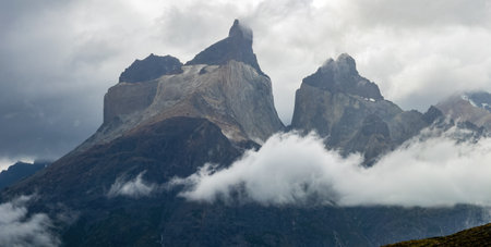 Majestic Mountain Peaks Emerge from Misty Cloudsの写真素材