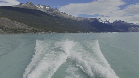 Sailing on Glacial Lake with Colorful Mountains in Background