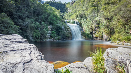 Tranquil Waterfall Oasis in Lush Green Forest Landscapeの写真素材