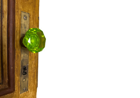 Vintage Green Glass Door Knob on Wooden Surfaceの写真素材