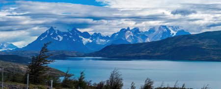 Majestic Mountain Range Overlooking a Serene Blue Lakeの写真素材
