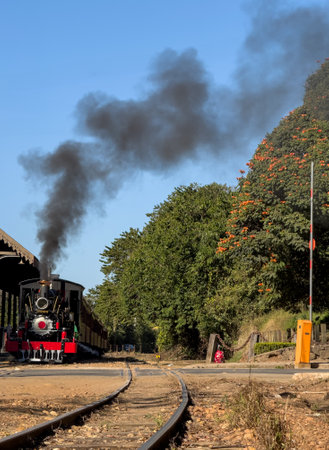 Vintage Steam Train Approaching on Rustic Railway Lineの写真素材