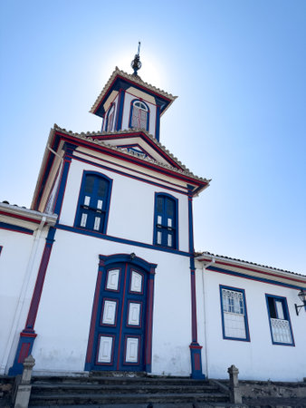 Sun Halo Over a Traditional Blue and White Church Facadeの写真素材