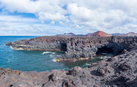 Majestic Volcanic Coastline with Rugged Cliffs and Oceanの写真素材