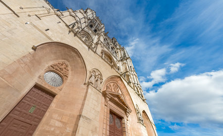 Majestic Gothic Cathedral Reaching Skyward in Daylightの写真素材