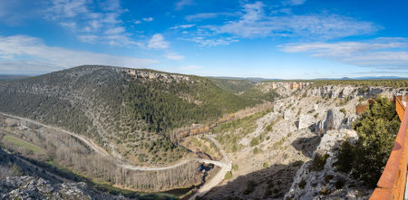 Scenic Mountain Valley with Lush Forests and River Viewの写真素材