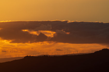 Majestic Wind Turbines Silhouette Against Sunset Sky