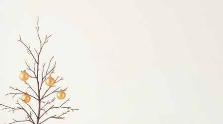 Christmas tree branch with golden balls on white background. Copy space.の写真素材