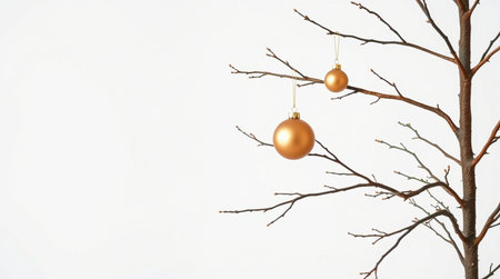 Christmas tree branch with golden balls on white background. Copy space.の写真素材