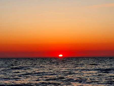 Sunset over the sea and a lake in Normandy. Beautiful color gradient in the skyの写真素材