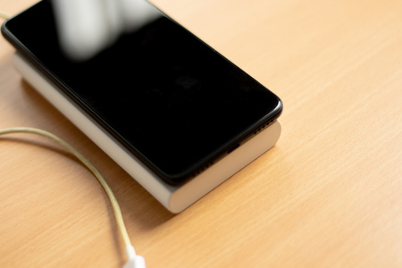 phone with power bank on the office table, on top phone