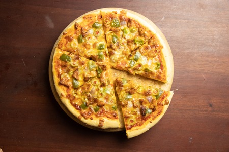 Pan Pizza slice take from top view with dark brown woodの写真素材
