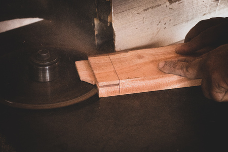 Carpenter working on woodworking machines in carpentry shopの写真素材