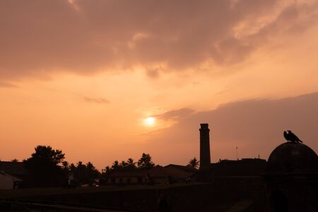sunset with clock tower gall sri lankaの写真素材