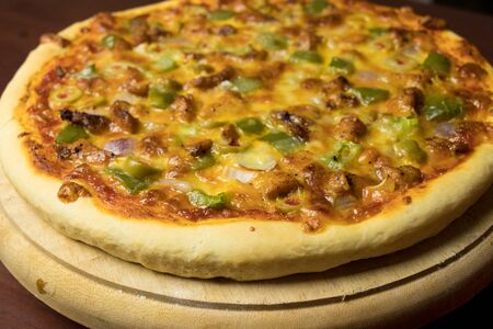 Pan Pizza take from top closeup view with dark brown woodの写真素材
