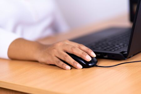 Female hand holding computer mouse