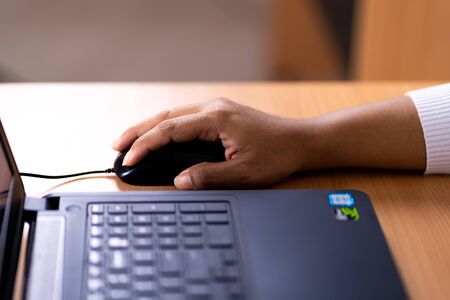Female hand holding computer mouse