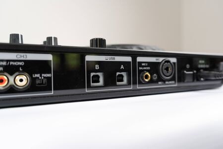 Cable to connect professional DJ midi controller to audio mixer.Concert equipment for home party.Disc jockey technology to mix digital music tracks.RCA audio cablesの写真素材