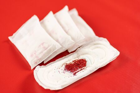 close up of woman hygiene protection on red background