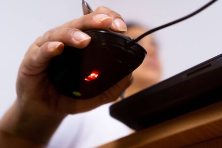 Female hand holding computer mouse