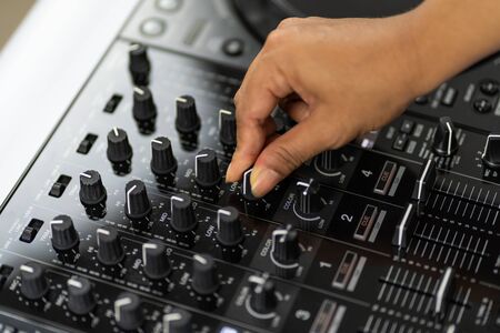 Hands of DJ mixing tracks on professional Dj Mixerの写真素材