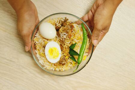 Delicious chicken biriyani hold with handの写真素材