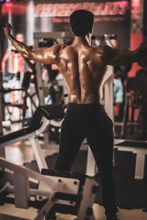 Overhead Cable Curl young man in the gymの写真素材