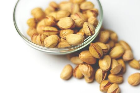 Dried pistachio nuts in class with white backgroundの写真素材