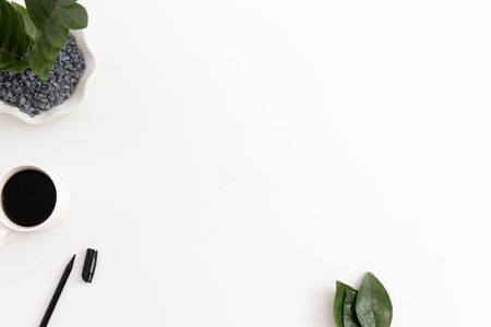 White office desk with office plant, coffee and pen. Top view with copy space, flat layの写真素材