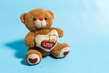 Teddy Bear toy alone with blue backgroundの写真素材