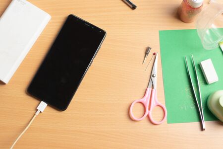 phone with power bank on the office table, zoom outの写真素材