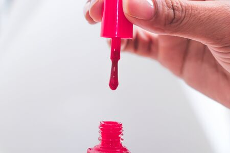 close up of a nail polish bottle and drop on white backgroundの写真素材