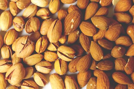 Dried pistachio nuts in class with white backgroundの写真素材
